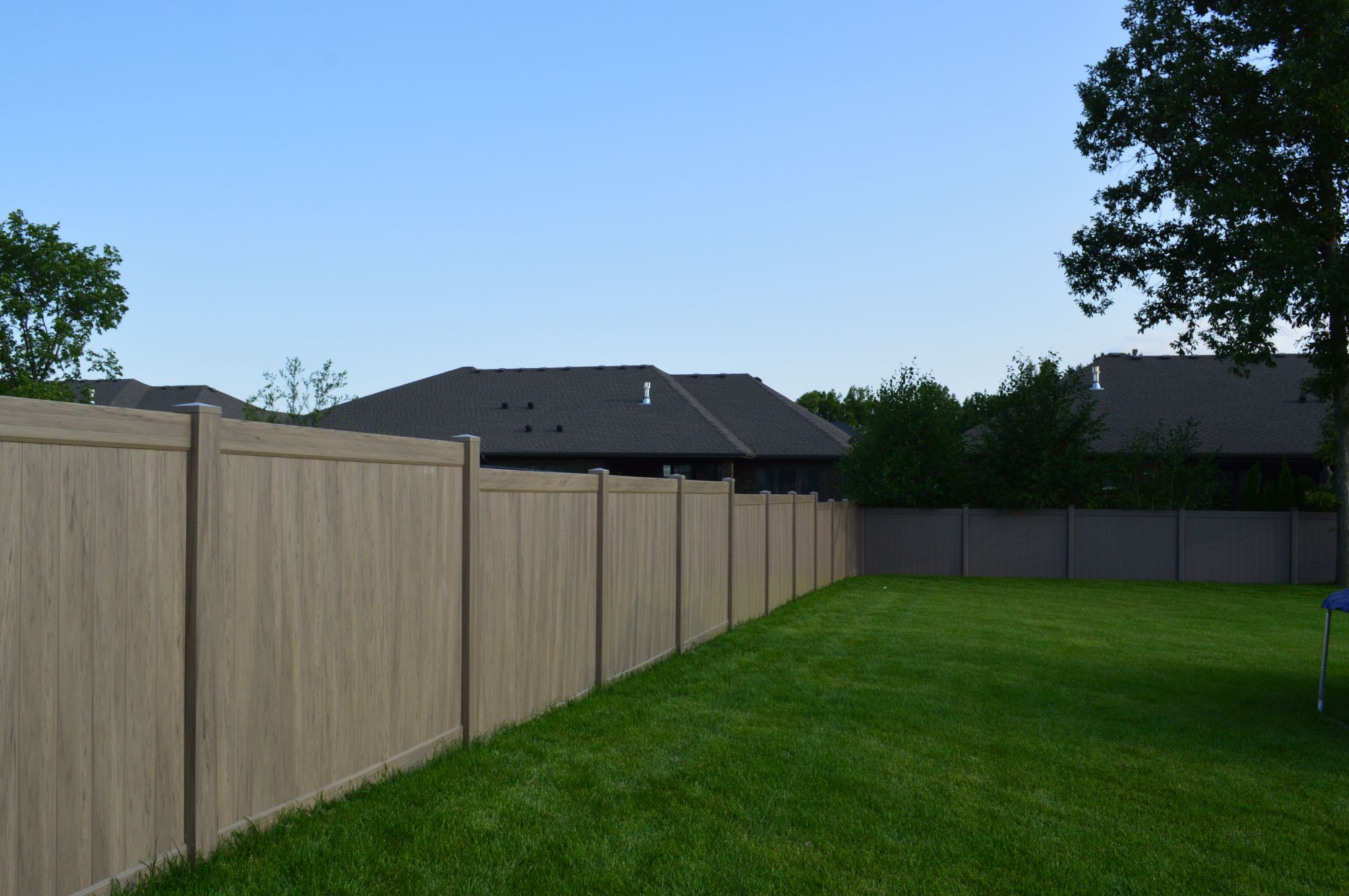 PVC Vinyl fence in Teak. One of the benefits of Green Teak vinyl fence is that it is a low-maintenance color. Unlike other colors, such as white or cream, Green Teak does not show dirt or debris as easily, which means that it requires less frequent cleaning and maintenance. Additionally, Green Teak is a timeless color that does not go out of style, which means that it will continue to look good for many years to come.