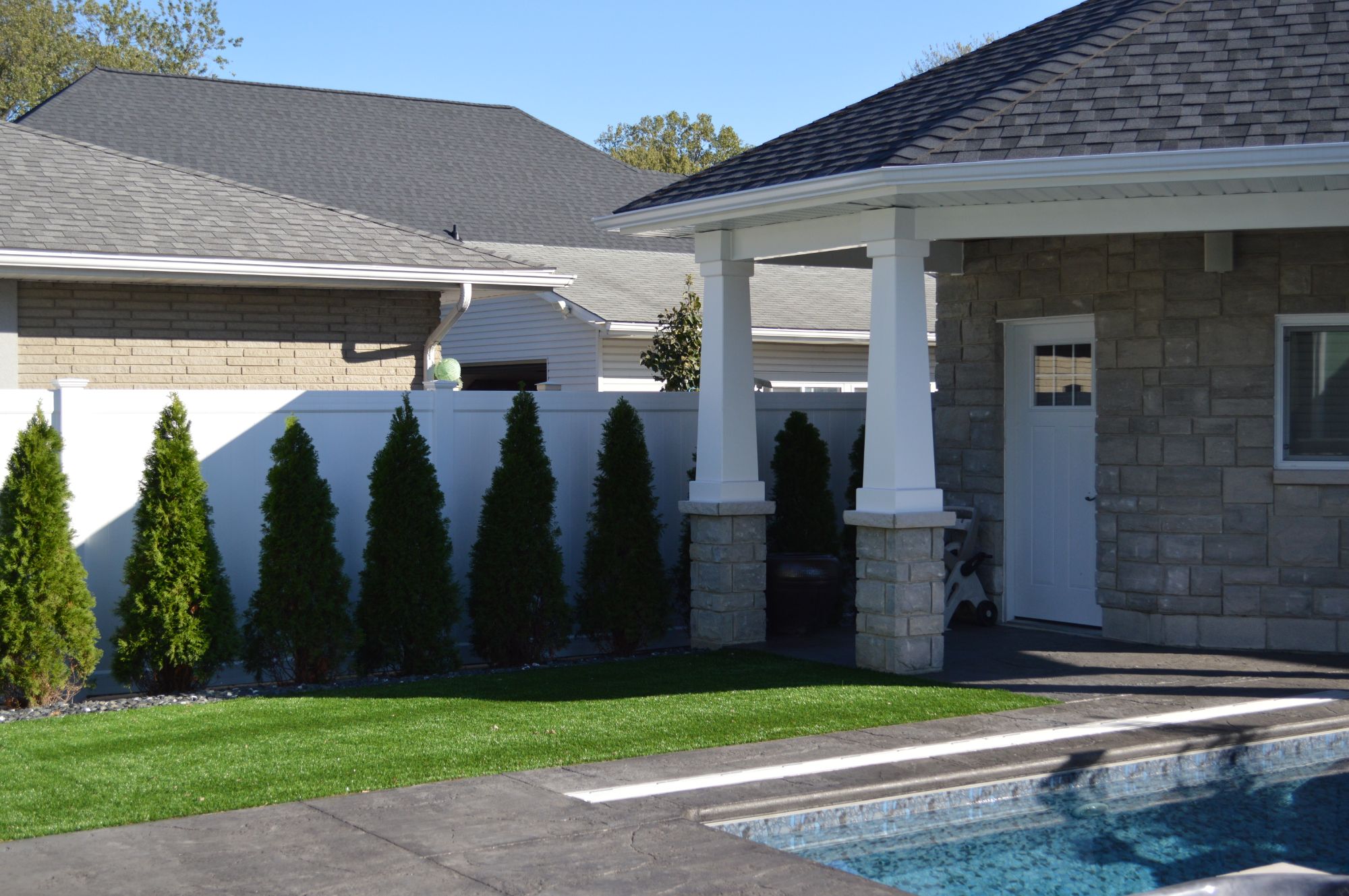 White PVC fence with a 1.5 inch x 5.5 inch nexus rail to give you perfect privacy while you swim in your pool. We install many PVC fences and would be happy to install another one of these in the Tecumseh area.